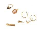 three gold rings and a ring with a pink stone on it