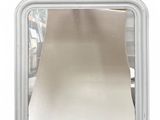 a small square mirror on a white surface