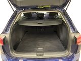 the back of a blue car with its trunk open and luggage in the trunk