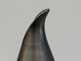 a black and silver vase sitting on a white table