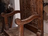 a wooden chair that is sitting in the middle of a room