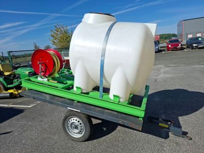 a large white tank on a trailer in a parking lot