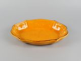 an orange bowl sitting on top of a table with a white background
