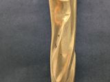 brass sculpture of a woman ' s torso on a blue background