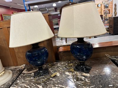 une paire de lampes bleues et blanches posées sur une table en marbre dans un magasin