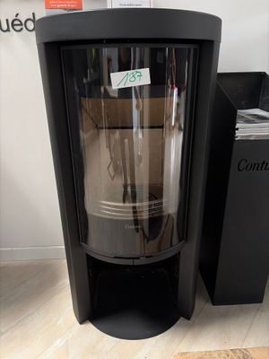 a black stove with a glass door in a room