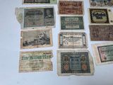 some old paper money sitting on top of a white table