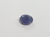 a blue sapphire stone sitting on top of a white surface