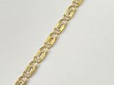 a close up of a gold chain bracelet on a white background
