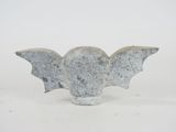 concrete sculpture of a bat on a white background