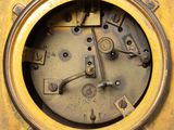 a close up of a clock on a yellow surface