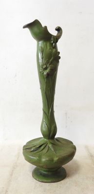 a green vase with a bird on top of it