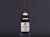 a bottle of wine sitting on top of a black table