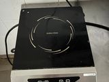 a stove with a black burner on top of it in a kitchen