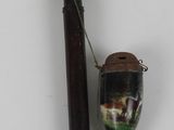 a pipe and a glass bottle on a white surface
