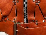 a brown leather jacket with a zipper on it