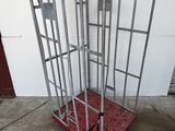 a metal cage that is sitting on top of a red platform