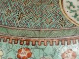 a close up of a decorative vase with birds on it