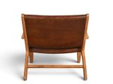 a brown leather chair on a white background