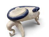 a ceramic crab that is sitting on a white surface