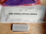 a bag of toothpaste and a toothbrush on a table