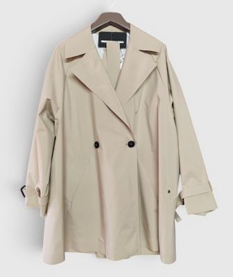 the trench coat is hanging on a hanger on a white wall