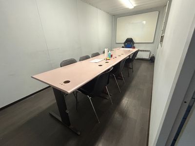 an image of a conference room with a table and chairs