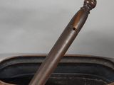 a wooden pipe holder with a pipe on top of it