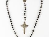 a close up of a rosary with a cross on it