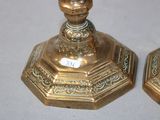 pair of antique brass candlesticks on a white background