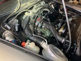 a picture of a car engine with its hood open