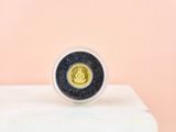 the gold coin is sitting on top of a white pedestal