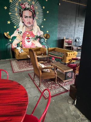a large mural of a woman on the wall in the living room