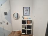 an image of a hallway with a mirror and a shelf