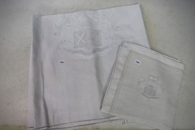 a white cloth with a monogram on it next to a white cloth with a monogram on it next to a white cloth with a monogram