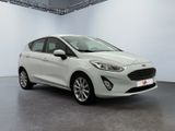 a white ford fiesta parked in a large room