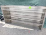 a metal shelf that has a green sign on it