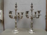 deux chandeliers en argent posés l'un à côté de l'autre sur une table