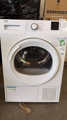 white washing machine in a warehouse with boxes and boxes in the background