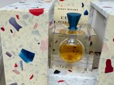 a bottle of perfume sitting on top of a box