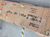 a cardboard box with writing on it sitting on the ground