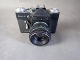 a black camera with a lens attached to it