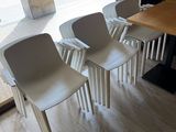 three chairs sitting in front of a table in a room