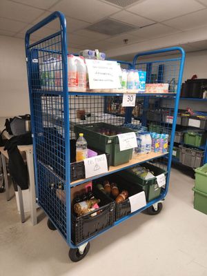 a blue cart that has many items on it