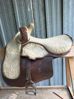a saddle that is sitting on top of a wooden chair