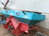 a blue and red boat sitting on the ground next to a pallet