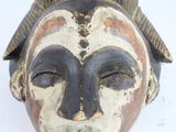 a close up of a mask on a white surface