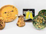 a lot of pottery items sitting on a white surface