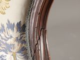 a close up of the back of a chair with a floral pattern on it
