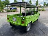 a green truck that is parked in a parking lot